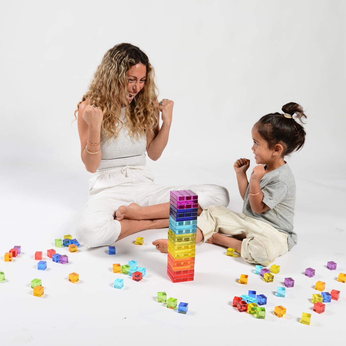 Newton's Tower mid-game, translucent blocks stacked in spectrum colours