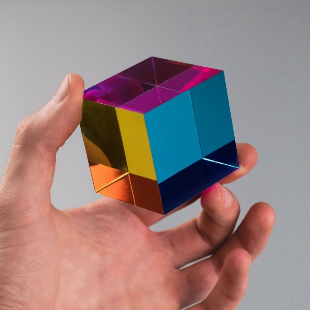 The Original CMY Cube catching the light, cyan, magenta and yellow overlapping