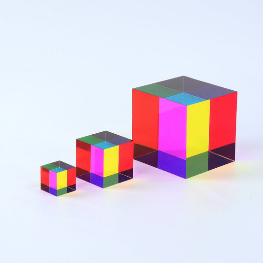 A translucent CMY Cube held up to the light, its cyan, magenta and yellow faces overlapping into new colours