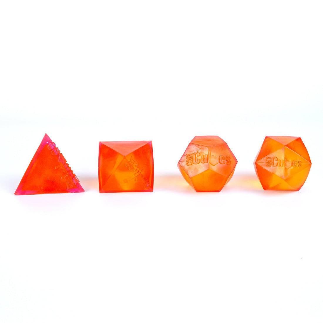 Several PolySquish geometric squishies in different colours arranged on a plain surface