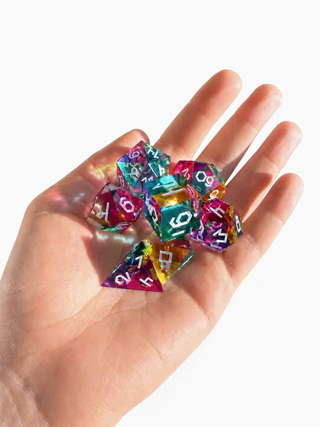 Hand holding a set of colour-mixing polyhedral dice