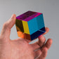 The Original CMY Cube catching the light, cyan, magenta and yellow overlapping